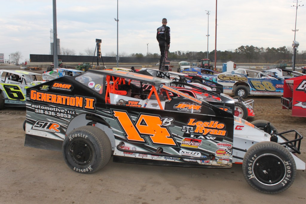 Dirtcars stationed inside the track's circuit waiting for the turn for the hot laps